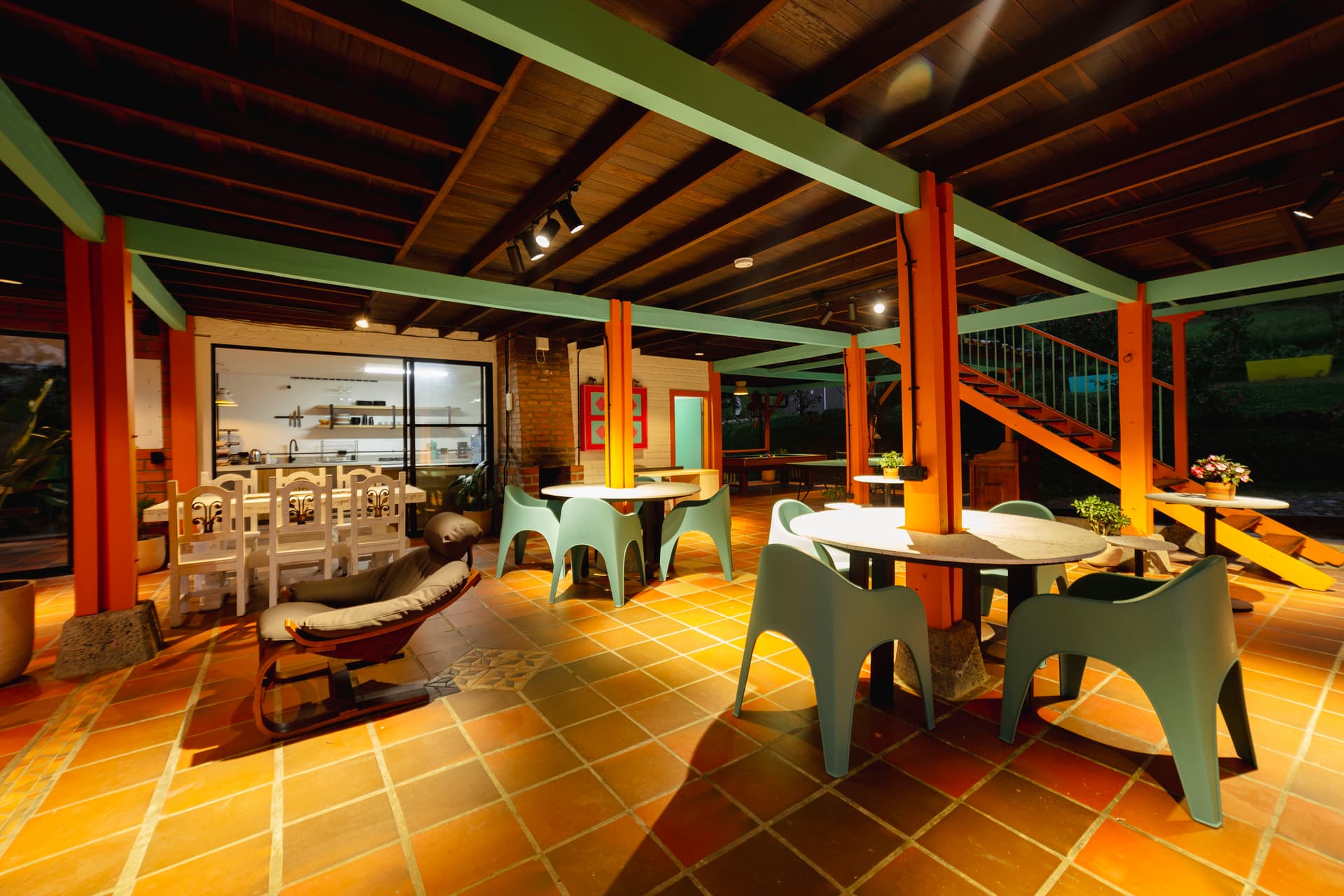 Group of backpackers sharing dinner and laughing together at Isla de Pascua hostel in Jardín