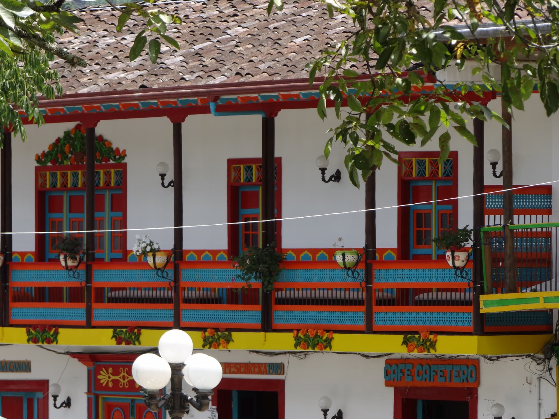 Row of colorful colonial buildings with painted doors in Jardín, Antioquia